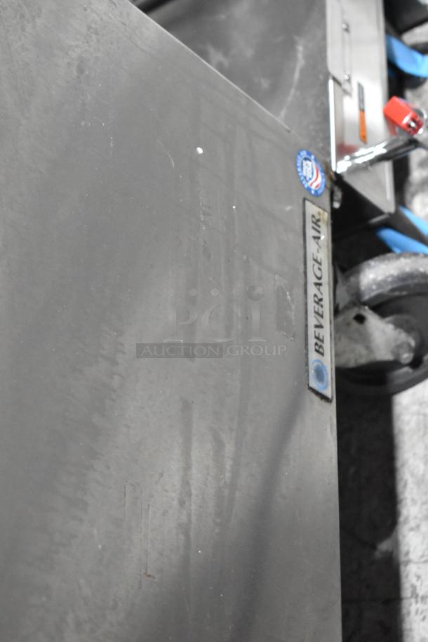 Beverage Air SPE48-18M stainless steel prep table with visible branding and casters, in good condition.