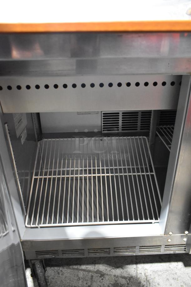 Beverage Air SPE48-18M stainless steel prep table, commercial casters, empty wire shelf, clean interior, 115V, 1 phase.
