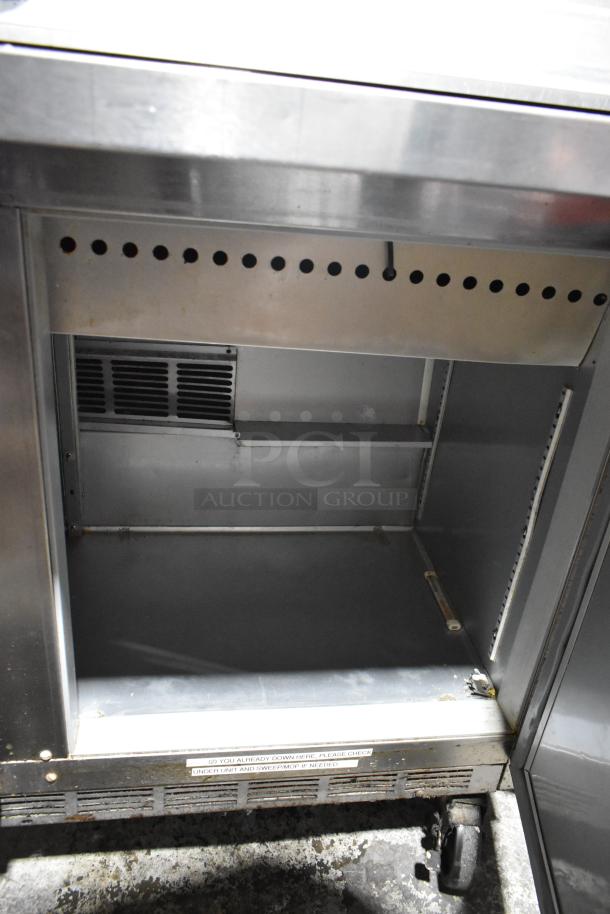 Beverage Air SPE48-18M-HMP stainless steel prep table with mega top, on casters. 115V, 1 phase. Interior view shown.