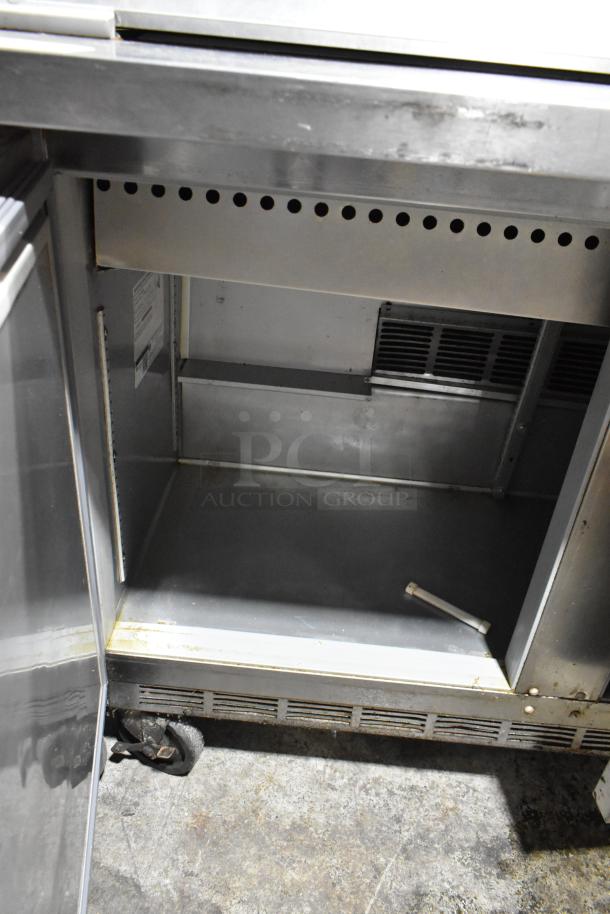 Beverage Air SPE48-18M-HMP stainless steel sandwich prep table on casters. Interior view, used condition. 115V, 1 phase.