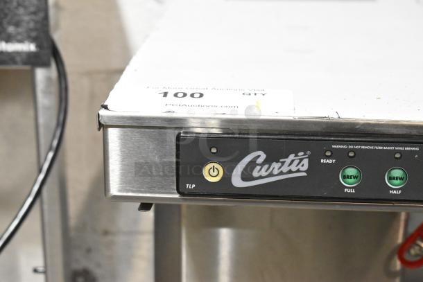 Curtis TLP12A19 countertop coffee machine in stainless steel with hot water dispenser. Features brew buttons, ready indicator. 120V.
