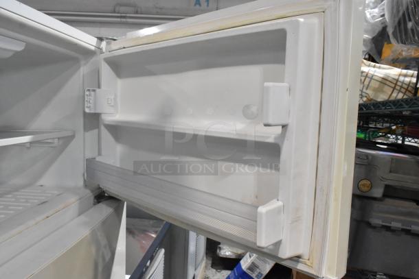 Whirlpool WRT511SZDW00 cooler with freezer open, showing shelves. Visible wear, 115 volts, 1 phase power.