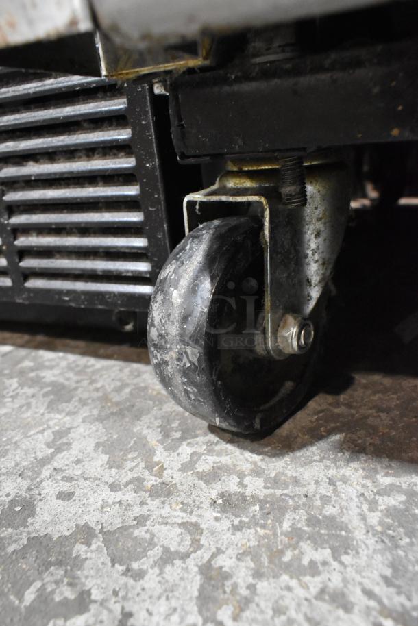 2017 True T-35 cooler caster wheel detail; shows wear. Stainless steel. 2-door reach-in, 115V, poly-coated racks.