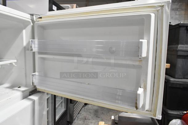 Whirlpool WRT511SZDW00 reach-in cooler/freezer, white, visible shelving, open door showing interior condition. 115V, 1-phase.