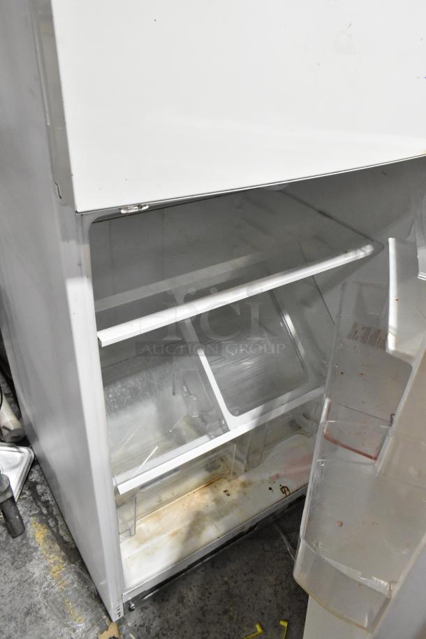 Whirlpool WRT511SZDW00 reach-in cooler with freezer, visible shelves, some wear and stains, 115 volts, 1 phase.