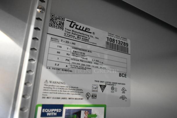 2024 True T-23-HC stainless steel single door cooler, poly-coated racks, commercial casters. Tag shows specs: 115V, 1 phase.