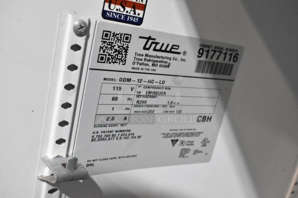 2017 True GDM-12-HC-LD cooler label with voltage, phase details, and refrigerant info. Features metal body, poly-coated racks.