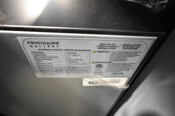 Frigidaire Gallery FGMIS1260 metal mini cooler merchandiser, 115 volts, 1 phase. Label shows specs and safety warnings.