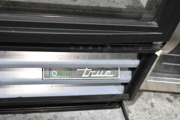 2018 True GDM-12-HC-LD cooler with single glass door, poly coated racks, "natural refrigerant" label, 115V, 1 phase.