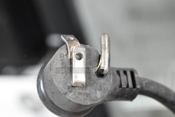 Close-up of the power plug for a 2018 True GDM-12-HC-LD commercial cooler, showing prong details and text.