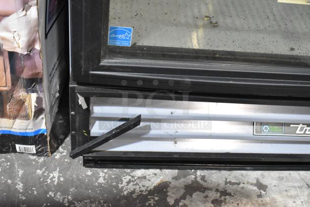 2018 True GDM-12-HC-LD cooler with single glass door, poly coated racks, Energy Star label, 115V, minor wear visible.