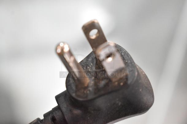 Close-up of a power plug for mini coolers, showing standard two-prong configuration.