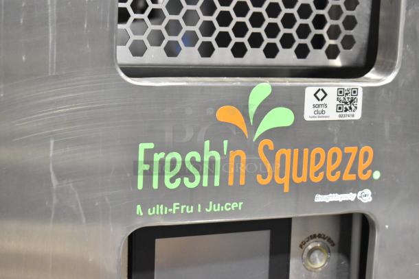 JBT Fresh N Squeeze stainless steel commercial citrus juicer with casters, 115 volts, 1 phase. Shows brand logo and power switch.