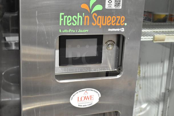 JBT Fresh N Squeeze stainless steel commercial citrus juicer, floor style with casters, 115V, 1 phase. Visible brand labels.