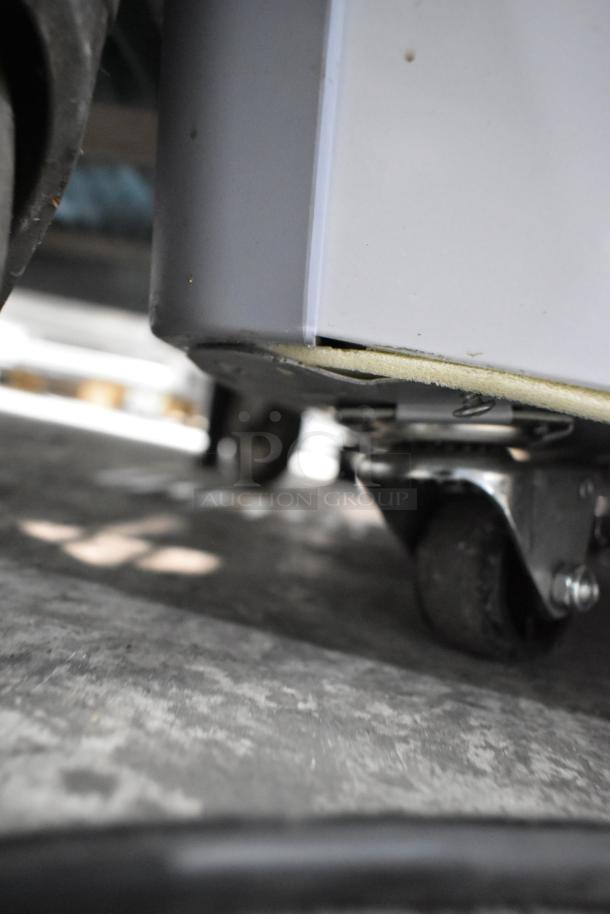 Avantco 360ADC12N ice cream dipping cabinet base, showing a caster wheel. Scratch and dent visible.