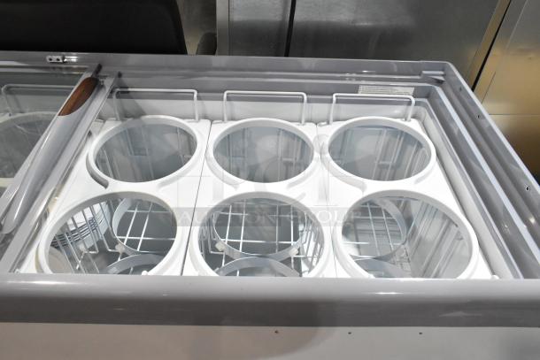 Brand new Avantco 360ADC12N 71" metal ice cream dipping cabinet with customizable tub collars, 115V, 1 phase.