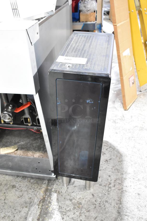 Metal flavor dispenser with black finish, vertical design, and visible plumbing connections. Includes a label marked "108."