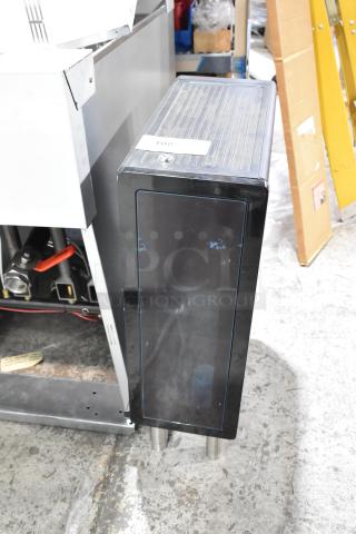 Metal flavor dispenser with black finish, vertical design, and visible plumbing connections. Includes a label marked "108."