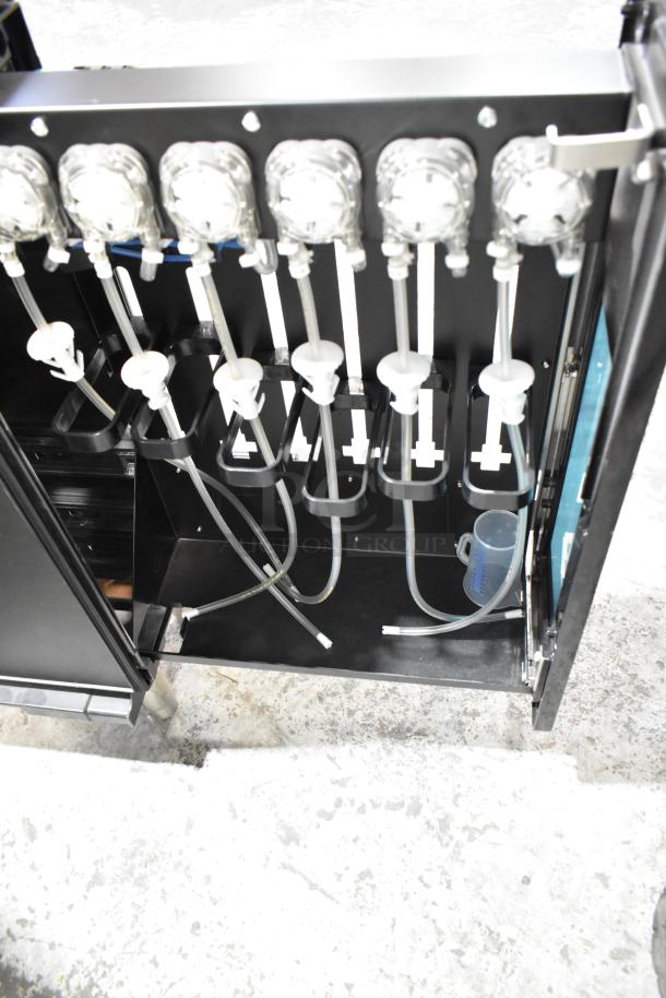 Metal flavor dispenser with multiple dispensing nozzles, tubes, and holders. Appears in good condition.