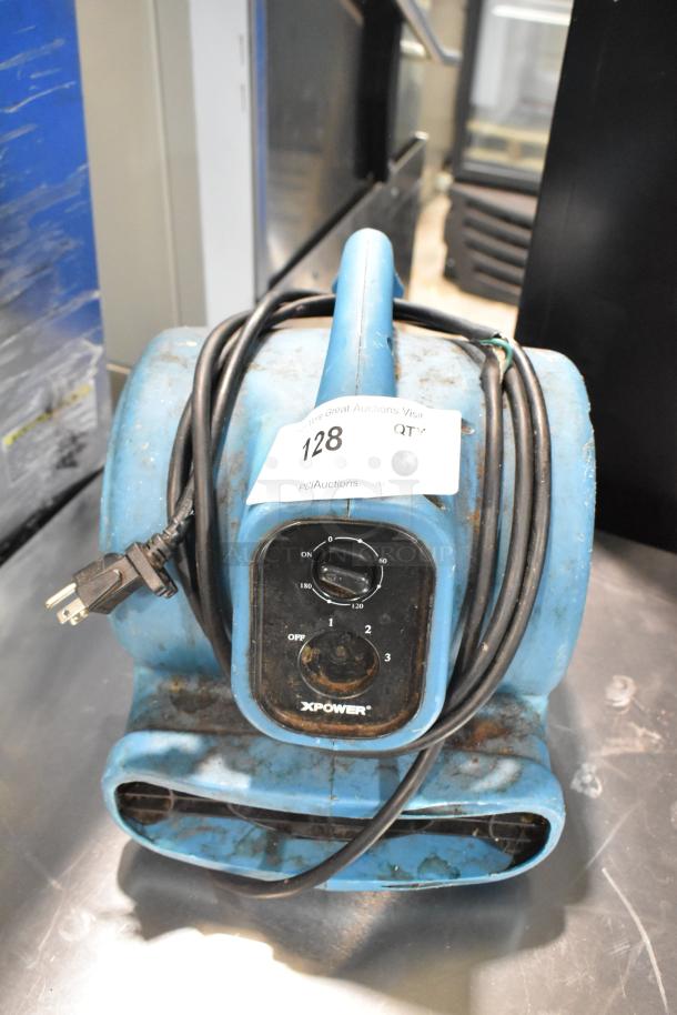 Xpower P-230AT Blue Air Mover, 120V, 1 Phase. Shows signs of wear. Control dial at front, attached power cord. Item tag visible.