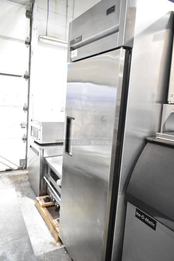True TG1R-1S-HC stainless steel commercial reach-in cooler with single door, poly-coated racks, on casters, like new.