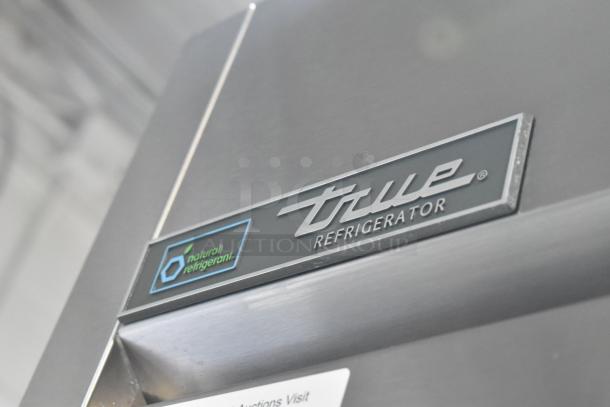 True TG1R-1S-HC stainless steel commercial cooler, single door, poly-coated racks, on casters, with natural refrigerant label.