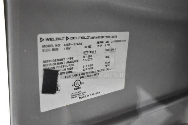 2021 Delfield 406P-STAR4 stainless steel undercounter cooler with commercial casters, model label detailing specs.