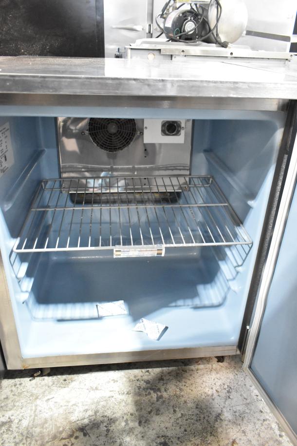 Delfield 406-STAR2 stainless steel undercounter cooler, single door, 115V, 1 phase, interior fan, wire shelf, visible serial tag.