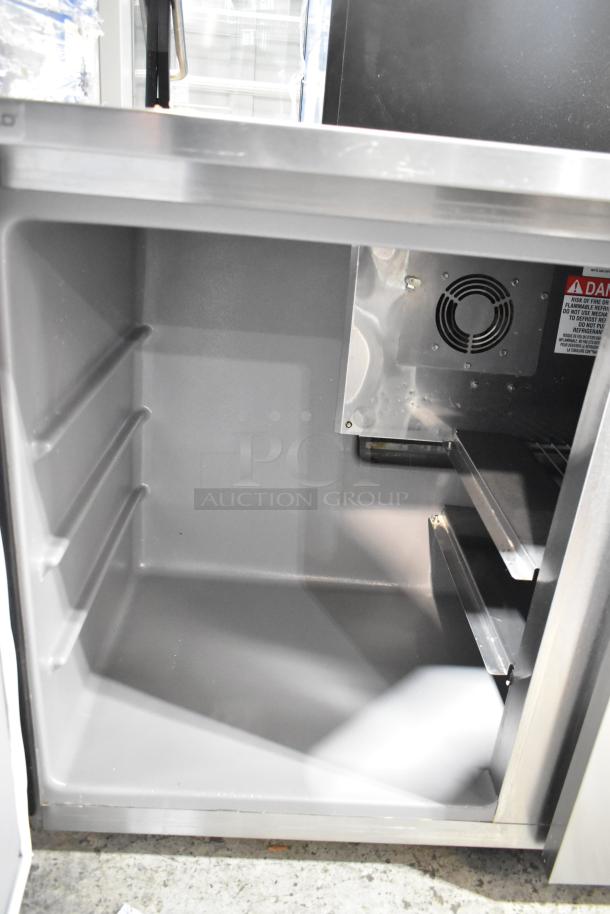 Delfield stainless steel 2-door undercounter cooler, 115 volts, 1 phase. Interior shelves and fan visible. Excellent condition.