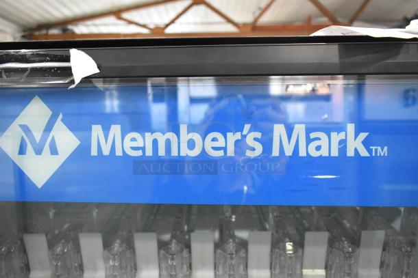 Metal commercial vending machine by Member's Mark with bill acceptor, visible label, and item rows, in good condition.