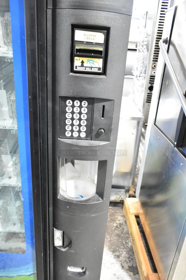 Metal commercial vending machine with bill acceptor, keypad, and transparent display. Accepts $1 bills, black casing.