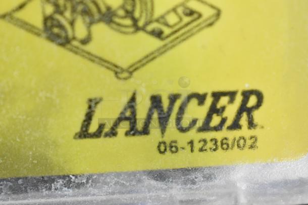 2016 Lancer 205 Carbonator label, showing brand name and model number. Yellow background, clear font, some wear visible.