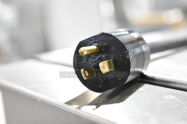 Power plug of JBT 2ND-GEN-MFJ-HE commercial citrus juicer, showing a 115-volt connection with gold-colored prongs.