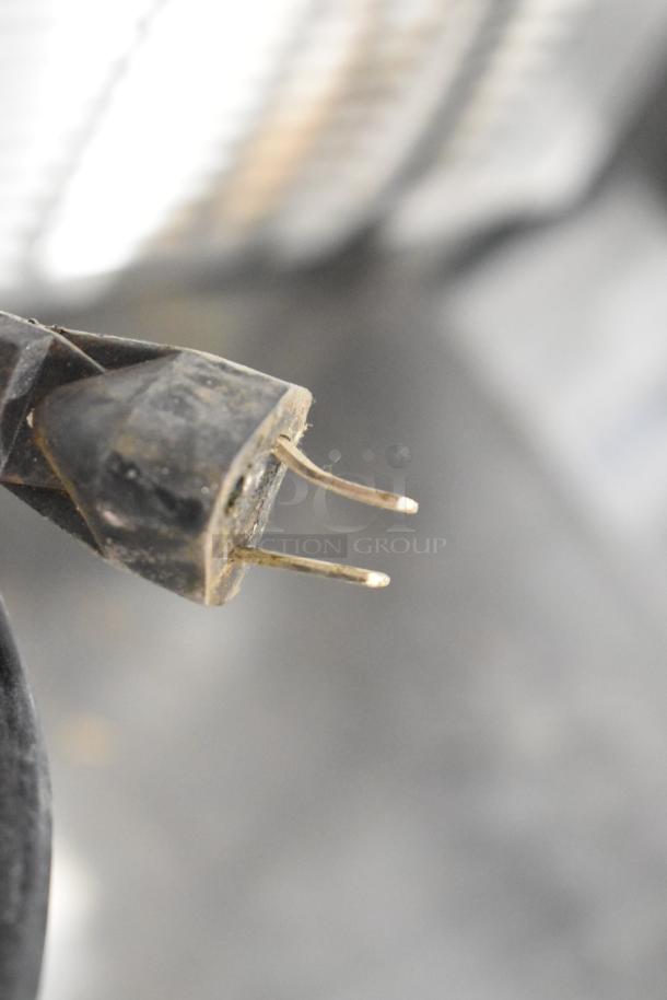 Alt text: Close-up of a two-prong plug of Globe CM22 stainless steel commercial meat grinder base, 115 volts, 1 phase.