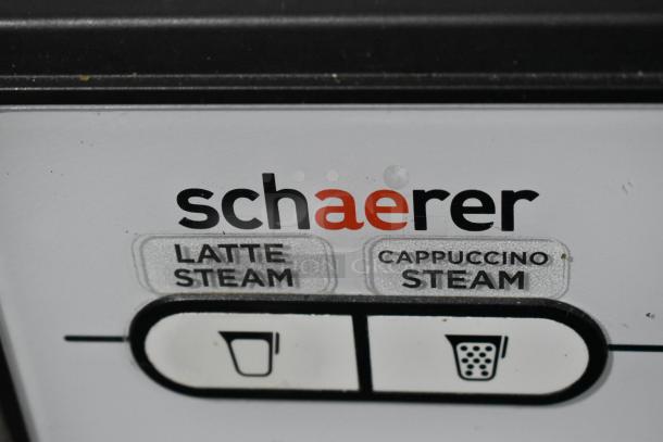 Schaerer Barista espresso machine control panel close-up, showing latte and cappuccino steam buttons.