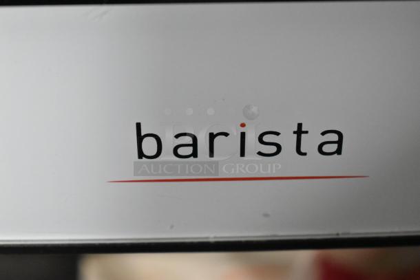 Schaerer Barista stainless steel commercial espresso machine logo, model name "Barista" visible.