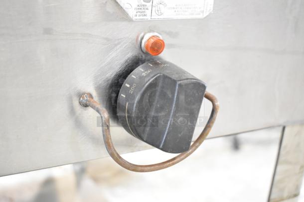 Duke Aerohot EP304 steam table control knob, showing temperature settings. Rust on handle. UL classification label visible.