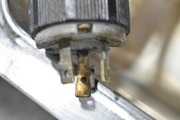 Close-up of the plug connector on a Duke Aerohot EP304 steam table. Features metal prongs, showing light tarnish.