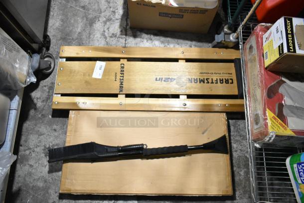 3 items including Craftsman heavy-duty creeper, Struts sawhorse, and scraper. Creeper branded "Craftsman," model 51004.