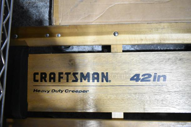 Craftsman Heavy Duty Creeper, 42in, visible branding. Good condition, made of sturdy wood for durability.