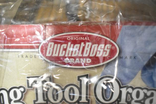 BucketBoss Rolling Tool Organizer label, red and white, indicating the brand. Part of auction lot with ladder dolly and pipe extender.