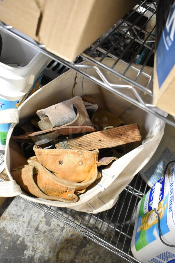 Tiered shelf with assorted items including a cloth bag filled with tools, a cardboard box, and a container of cat litter.