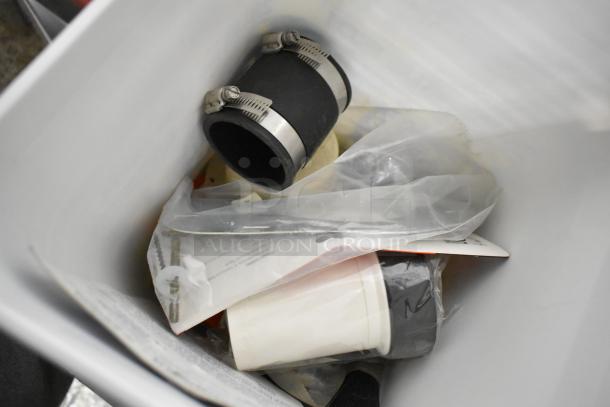 Tier lot including ladder dolly, rolling tool organizer, and toilet pipe extender in a container. Various items, mixed condition.