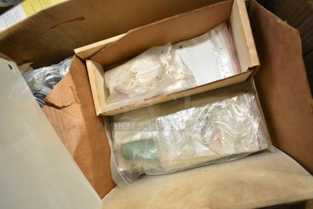 Auction lot box with file folders, plastic sheeting, doorknob, and outlet covers in fair condition, packaged in plastic bags.