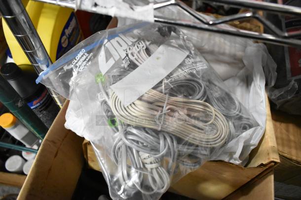 A lot of various items including a Ziploc bag of cords, bottles, and storage boxes; mixed condition visible.
