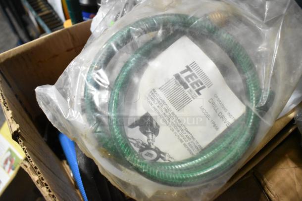 Box with assorted items including TEEL drill driver hose, file folders, and more. Hose in packaging; model 1P866.