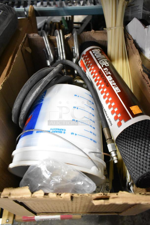 Auction lot with assorted items including a plastic bucket, coiled hose, non-slip liner, and miscellaneous hardware, in used condition.