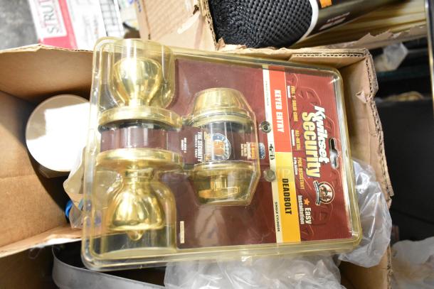 Auction lot including Kwikset Security deadbolt set, file folders, plastic sheeting in box. Items appear new in packaging.