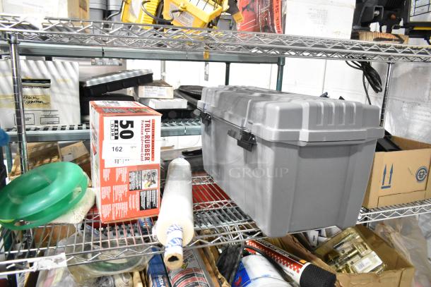 Tiered lot with Tru Rubber extension cord and gray poly toolbox on a metal shelf, surrounded by various tools and supplies.