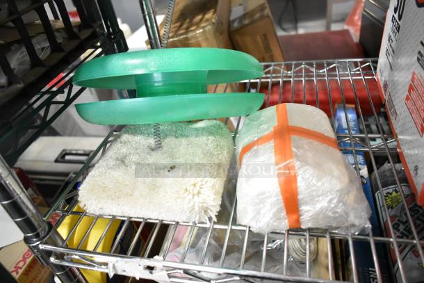 Auction lot with miscellaneous items including a Tru Rubber Extension Cord and a gray poly tool box. Items on wire shelving.